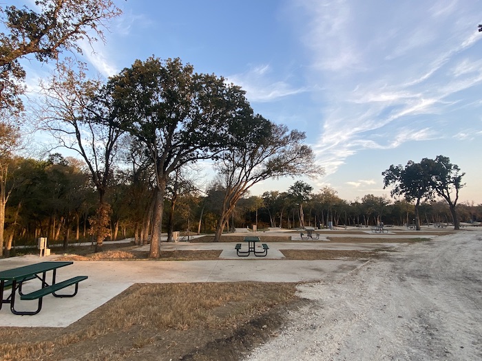 Over 100 Full Hookup RV sites at The Woods RV and Cabin Resort, offering water, sewer, electric (30/50AMP), free WiFi, a dog park, laundry facilities, showers, a clubhouse, and complimentary coffee for a comfortable and convenient stay.